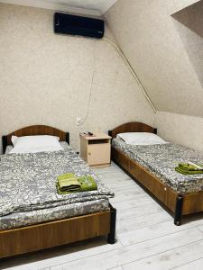 2 Betten nebeneinander in einem Zimmer in der Unterkunft Green Hotel in Taschkent