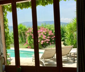 a window view of a pool from a house at Stunning Mountain Views with Secluded Private Pool in La Roquette-sur-Var