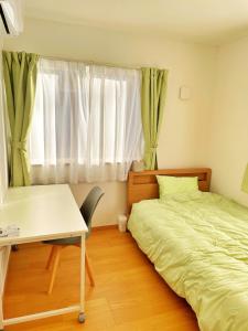 Postel nebo postele na pokoji v ubytování グローカル春日居温泉