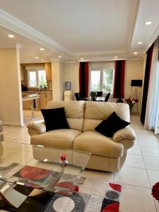 a living room with a couch and a table at Wonderful 3 bed duplex in sought after prime community in Side