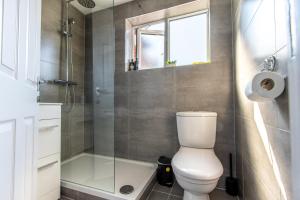 a bathroom with a toilet and a glass shower at Warburton House, Newark - Walking distance from North Gate Train Station & Market Place in Newark upon Trent