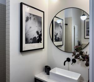 a bathroom with a sink and a mirror at Tranquil Old Town Retreat in Warsaw