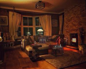 a living room with a couch and a table at Daweswood - Luxury cottage, lake access & hot tub in Canterbury