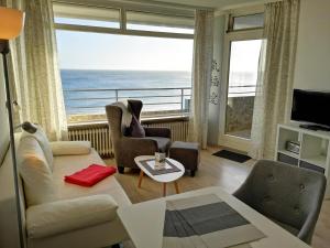 a living room with a view of the ocean at Strandhotel Wohnung 68 in Dahme