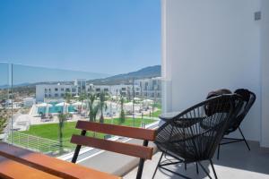 a balcony with a bench and a view of a city at Luxury apartment with roof terrace in Kyrenia
