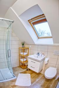 a bathroom with a sink and a shower at Hotel a Restaurace Růže in Podbořany