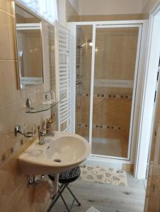 a bathroom with a sink and a shower at Magnólia Vendégház in Villány