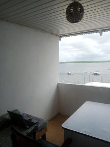 a room with a table and a view of the water at Al-reidy House in Lamu