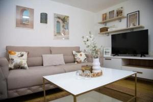 a living room with a couch and a table at Summer House with Heated Swimming Pool in Mostar