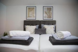 a bedroom with a large bed with two pillows on it at Summer House with Heated Swimming Pool in Mostar +18 photos