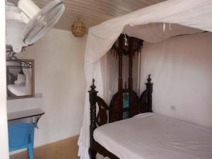 a bedroom with a bed with a canopy at Al-reidy House in Lamu