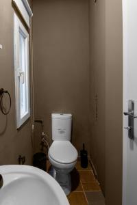 a bathroom with a white toilet and a window at Fully Equipped & Modern Designed Spectacular 3BR in Istanbul