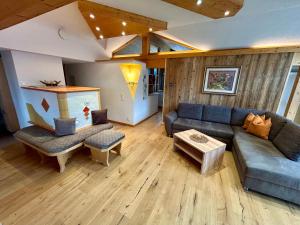 a living room with a couch and a table at Alpenapart Singer - contactless check-in in Reutte