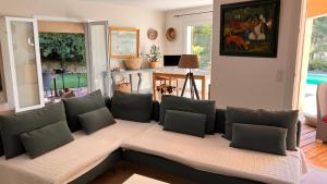 a living room with a couch with pillows at LA CIVADE in La Ciotat