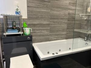 a bathroom with a tub and a glass shower at Ensuite Room with Private Bathroom at Walsall in Walsall