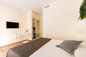 a bedroom with a bed and a tv on a wall at Borghetto Guest House in Rome