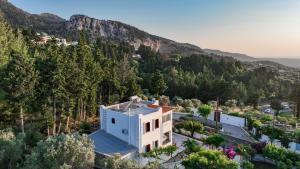 an aerial view of a white building with a mountain at Villa Sea View Gem Steps to Zia Square Hot Tub in Lagoúdi Zía