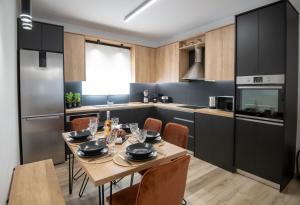 a kitchen with a table and chairs in a room at Olive Forest Villa in Koxaré