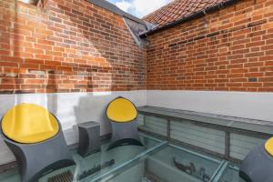 two yellow chairs sitting on top of a glass floor at Sandy Castle in Southwold