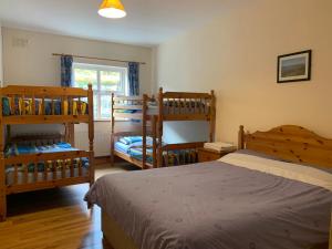 a bedroom with two bunk beds and a window at Clare's Rock Self-catering Accommodation in Carron