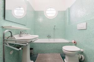a bathroom with a sink and a toilet and a tub at Promenade des Anglais 2 Bdr Large Terrace in Nice