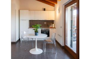 a kitchen with a table with a plant on it at Bes Residence Bergamo Polaresco in Bergamo