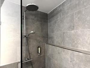 a shower with a glass door in a bathroom at Grimm's Potsdamer Platz in Berlin