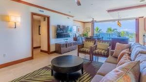 a living room with a couch and a table at Ko Olina Beach Villas B410 in Kapolei