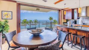a kitchen and dining room with a table and chairs at Ko Olina Beach Villas B410 in Kapolei