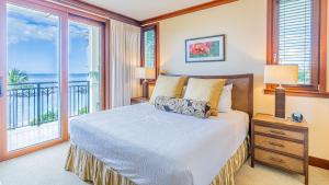 a bedroom with a bed with a view of the ocean at Ko Olina Beach Villas B410 in Kapolei +32 photos