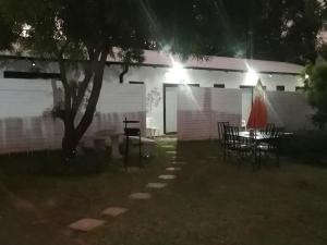 a table and chairs in a yard at night at Klein Parys in Parys