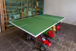 a ping pong table with two toy cars around it at Katica Apartman in Zalakaros