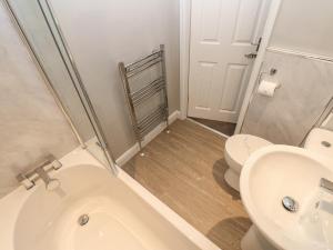 a bathroom with a toilet and a sink at Foxglove Cottage in Richmond +20 photos