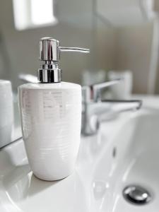 a soap dispenser sitting on top of a bathroom sink at Ligeti Bástya Vendégház in Liget +60 photos