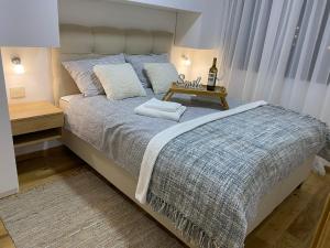 a bedroom with a large bed with a table on it at Apartman ConVista Zlatibor in Zlatibor