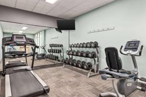 a gym with treadmills and exercise equipment in a room at Ramada By Wyndham Niagara Falls near the Falls in Niagara Falls