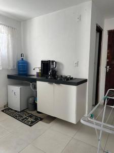a kitchen with a sink and a counter top at Casa de Vó in Campina Grande