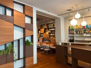 a bar in a restaurant with wooden walls at Best Western Plus Park Hotel Pordenone in Pordenone