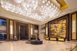 a lobby with a chandelier in a building at Hilton Nanjing in Nanjing