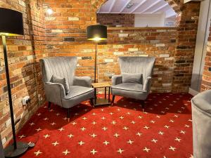 a room with two chairs and a red carpet at The Angel Hotel in Alton +56 photos