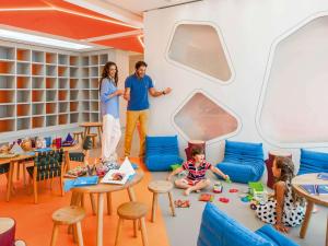 a man and a woman and a child in a play room at Sofitel Tamuda Bay Beach And Spa in M'diq