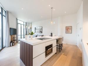 a kitchen with an island in the middle of a room at Brussels Splendor Suites in Brussels