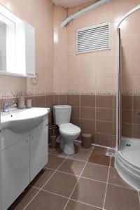 a bathroom with a toilet and a sink and a shower at Fully Equipped & Modern Designed Spectacular 3BR in Istanbul
