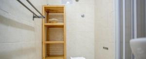 Un baño con ducha con estante de madera. en House in Vatican 2, en Roma 23 fotos más