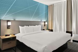 a large white bed in a hotel room at Comfort Suites North Fossil Creek in Fort Worth