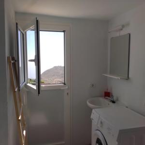 a bathroom with a window and a washing machine at Vista del Sur in Alajeró