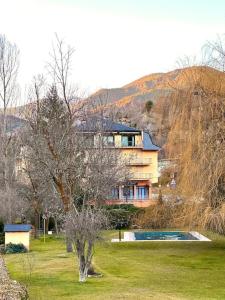 a house on top of a hill with a swimming pool at Acogedor alojamiento en Martinet, Cerdanya. in Martinet