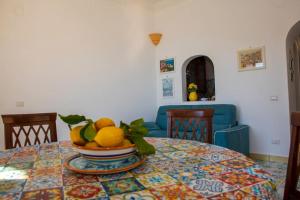 a table with a bowl of fruit on top of it at M'incanto in Positano