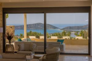 a living room with a view of the ocean at Messinian Nest in Gialova