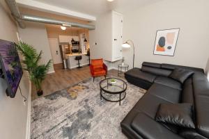 a living room with a black couch and a table at The Secret West Loop Oasis in Chicago